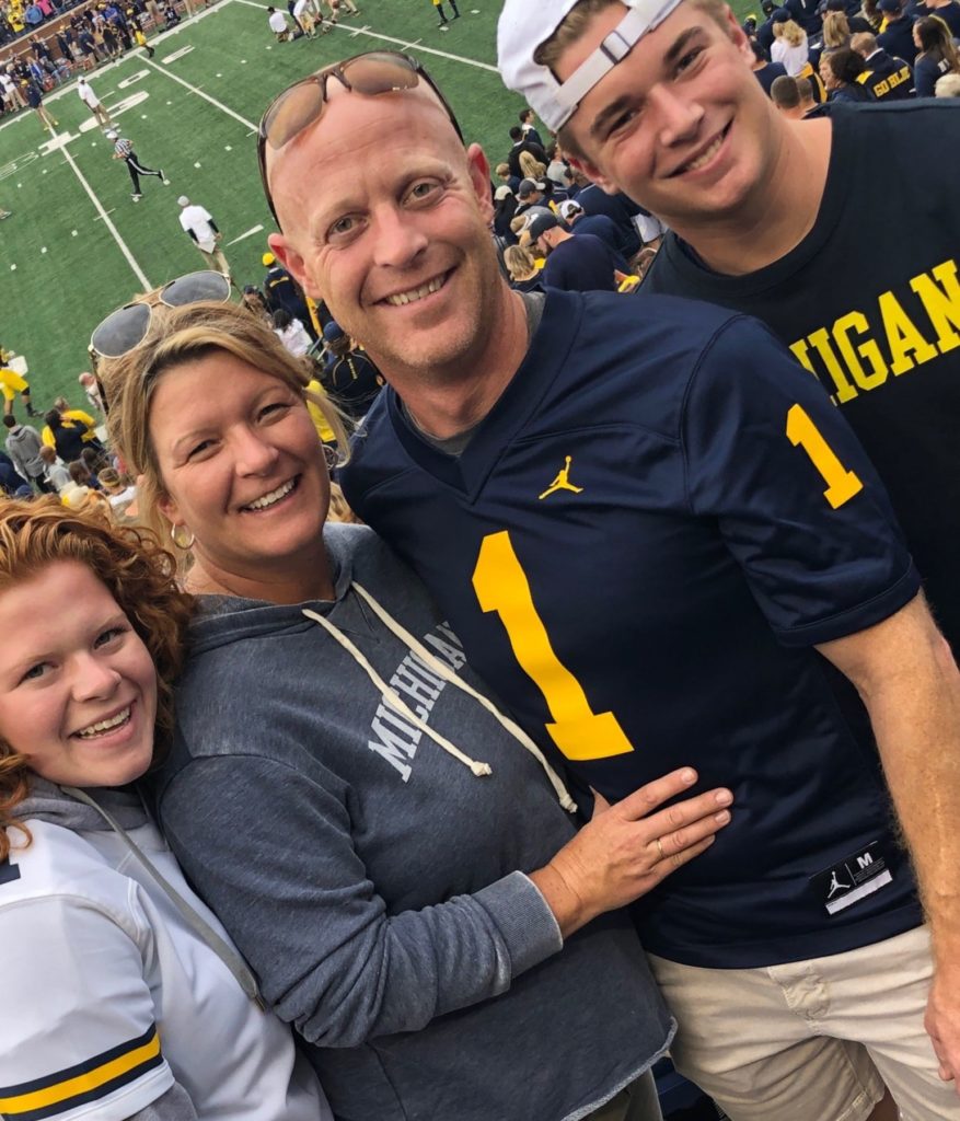Nate Koetje and his family posed for a photo at a University of Michigan football game