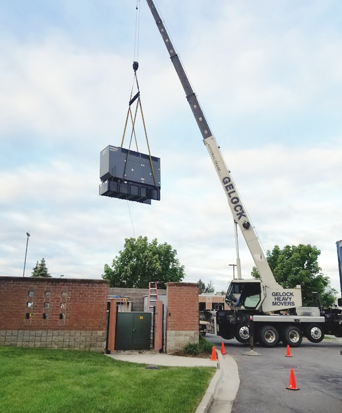 generator being lifted by a crane