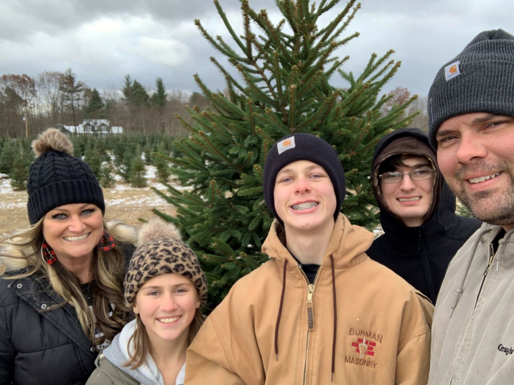 chris and family at a tree farm