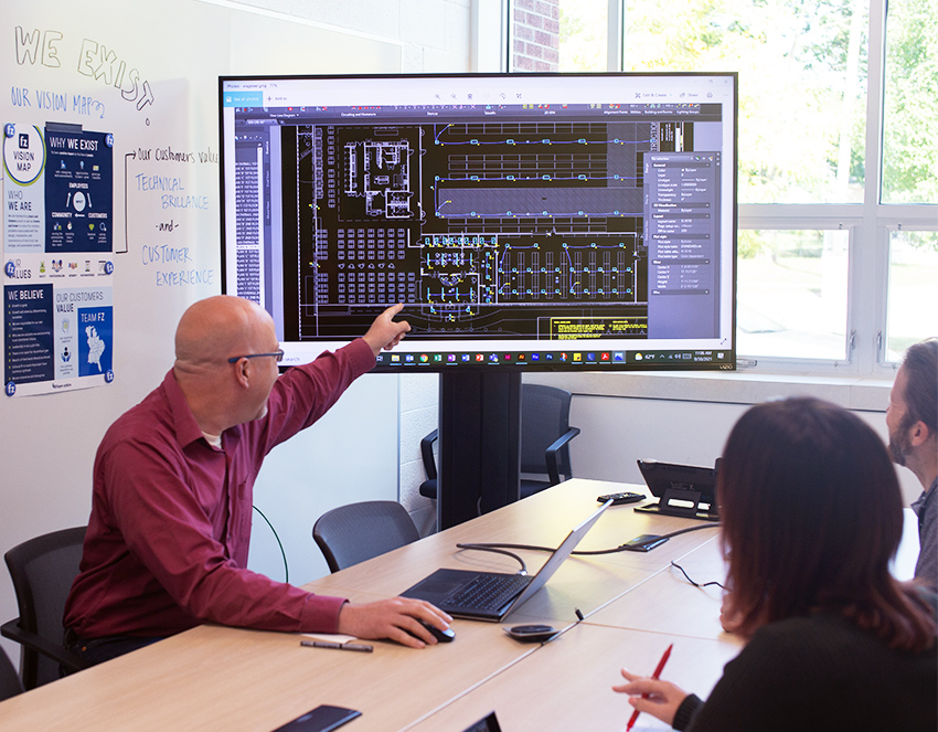Design services electrical engineers discussing a project