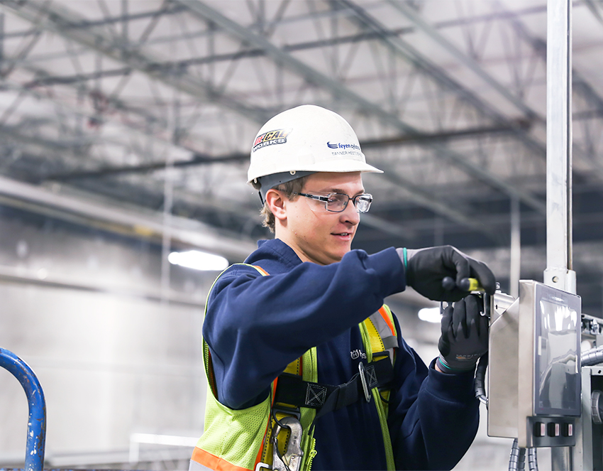 ES page - Tanner electrician working on equipment