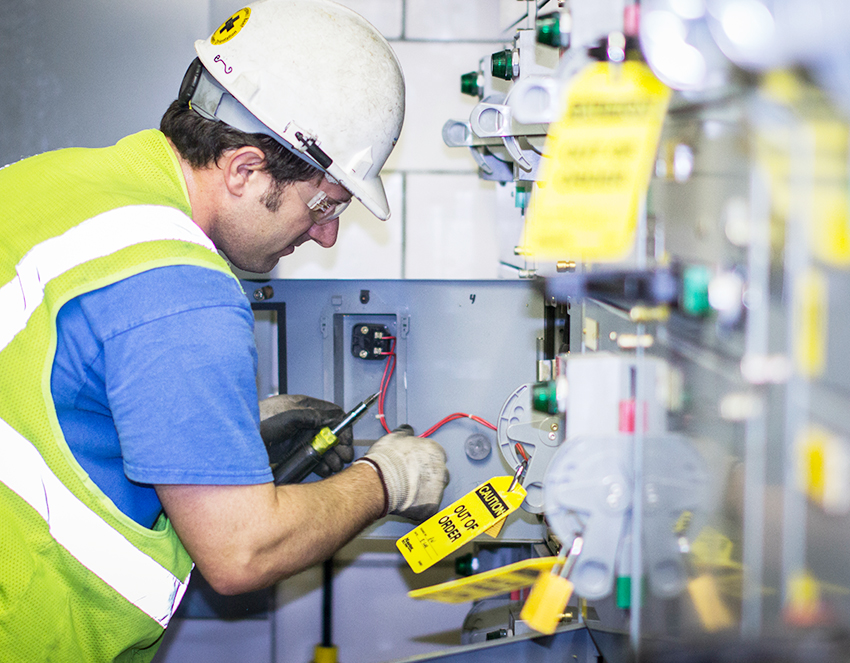 electrician working on LOTO tags in a facility