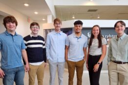 Aimee Zang, Evan Klein, Izaiah Marve, Cam Gavette, Skyler Dare, and KayeLee Martens standing lined up in a group photo.